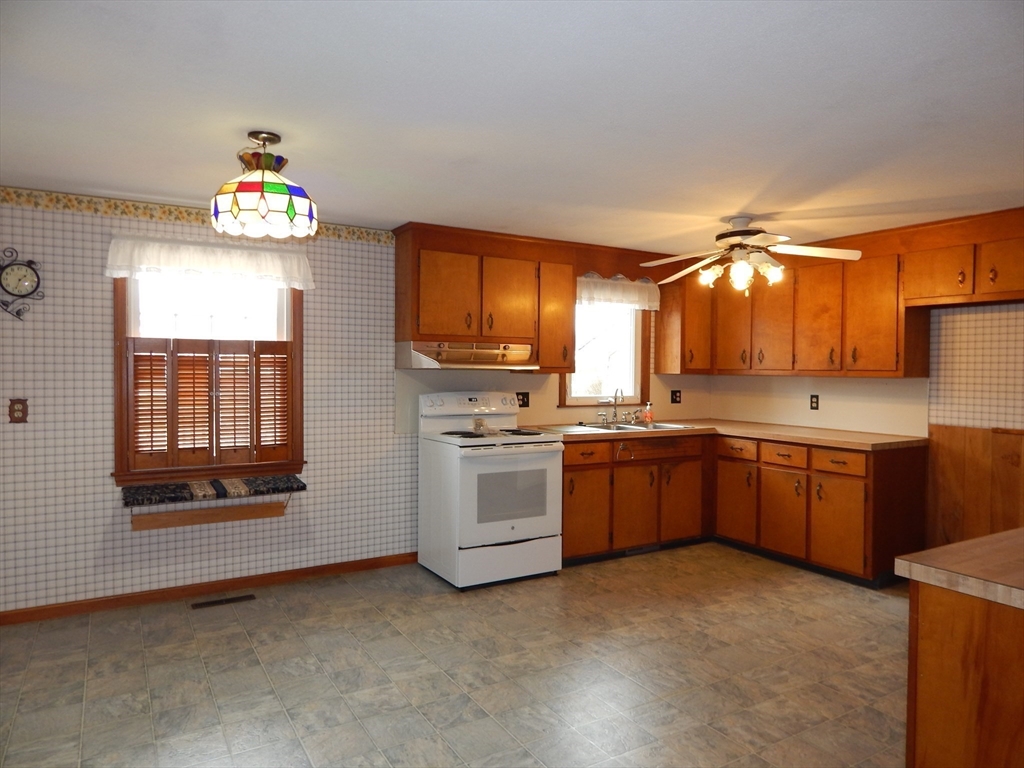 8 Chester Street Montague, MA 01376 - Photo 6 of 32 a kitchen that has a lot of cabinets in it and wooden floors