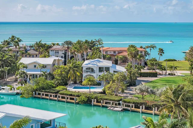 an aerial view of a house with a garden and lake view