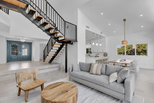 a large kitchen with kitchen island a table and chairs in it
