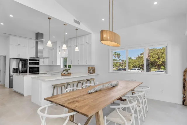 a kitchen with stainless steel appliances granite countertop a sink a stove and a refrigerator