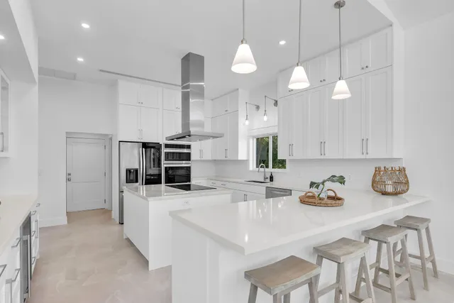 a kitchen with a sink a counter space appliances and cabinets