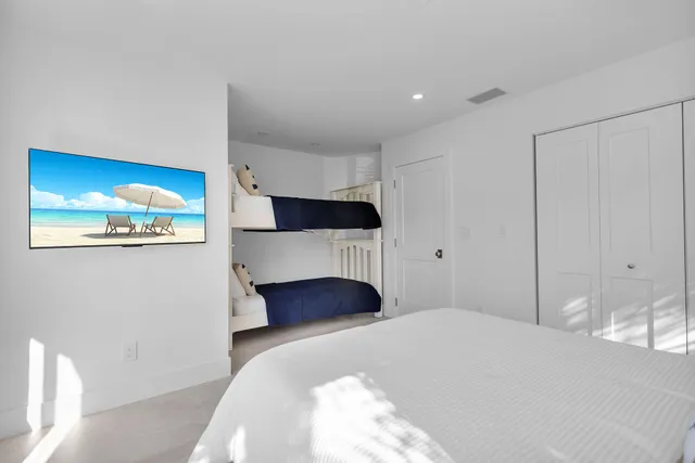 a bedroom with a bed and a large window