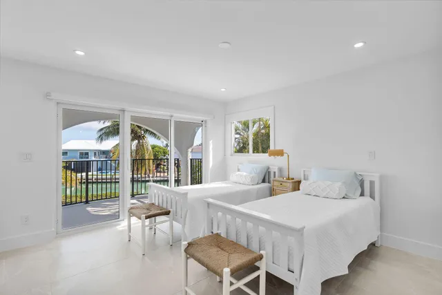 a bedroom with a large bed and a night stand