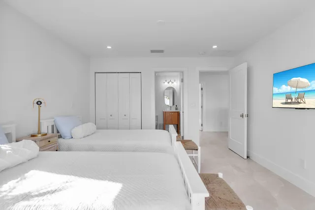 a view of a swimming pool with lawn chairs and plants