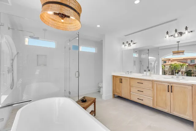 a view of a lake with a floor to ceiling window next to a yard