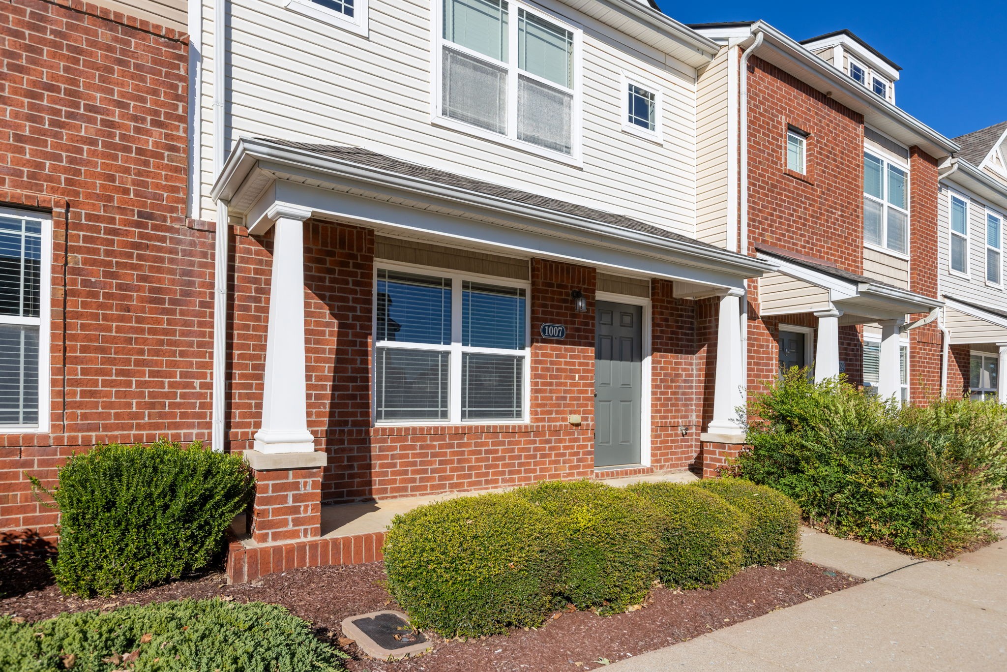 1007 Wells Way Spring Hill, TN 37174 - Photo 3 of 15 a view of a brick house with a large windows and flower plants
