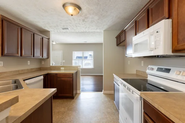 a kitchen with a sink a stove and cabinets