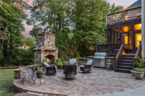 a view of a patio with table and chairs potted plants with wooden floor and fence
