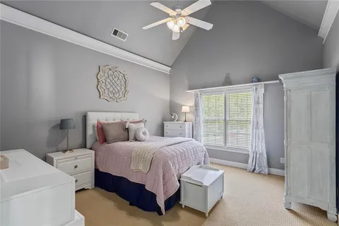 a bed room with a bed and a chair
