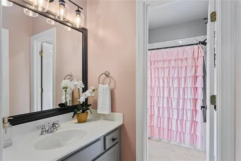 a bathroom with a sink toilet and mirror