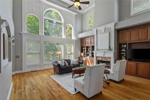 a dining room with furniture a chandelier and wooden floor