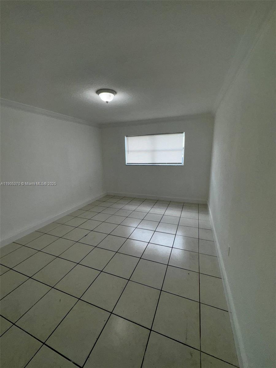 5150 West 12th Avenue, Unit 115 Hialeah, FL 33012 - Photo 11 of 14 a view of an empty room and window