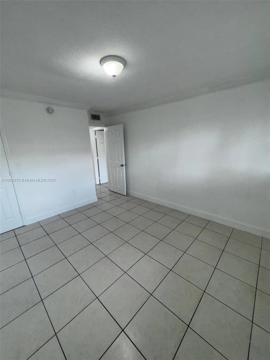 5150 West 12th Avenue, Unit 115 Hialeah, FL 33012 - Photo 13 of 14 a view of an empty room and wooden floor