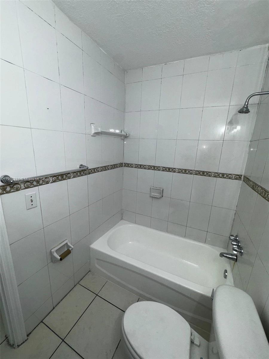 5150 West 12th Avenue, Unit 115 Hialeah, FL 33012 - Photo 6 of 14 a bathroom with a toilet and shower