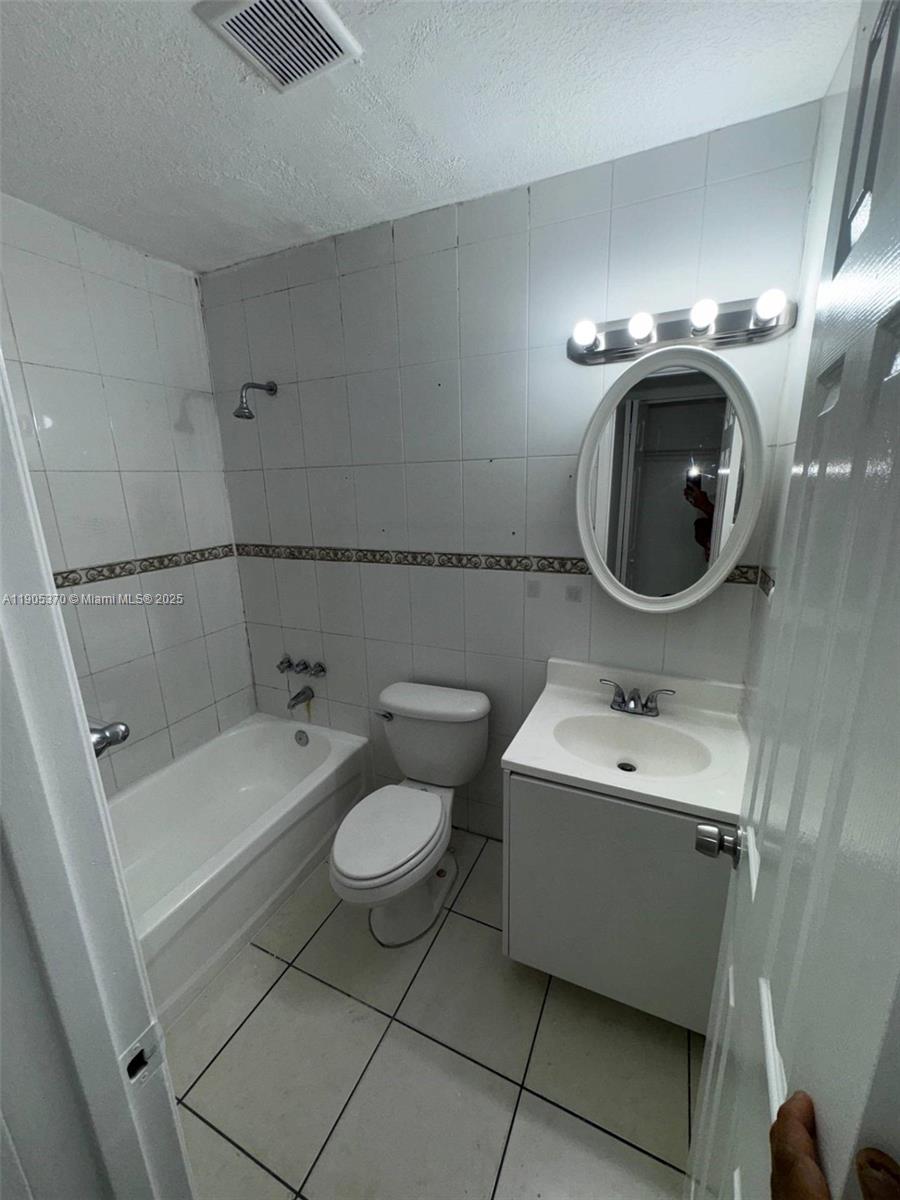 5150 West 12th Avenue, Unit 115 Hialeah, FL 33012 - Photo 7 of 14 a bathroom with a sink and mirror