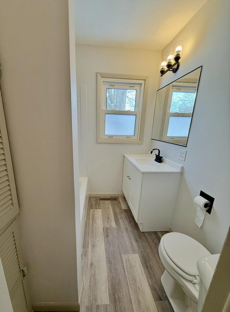 281 East Sprague Street Bement, IL 61813 - Photo 11 of 24 a white toilet sitting next to a bathroom sink