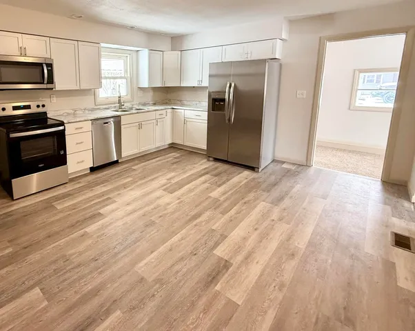 a kitchen with stainless steel appliances a refrigerator sink and stove