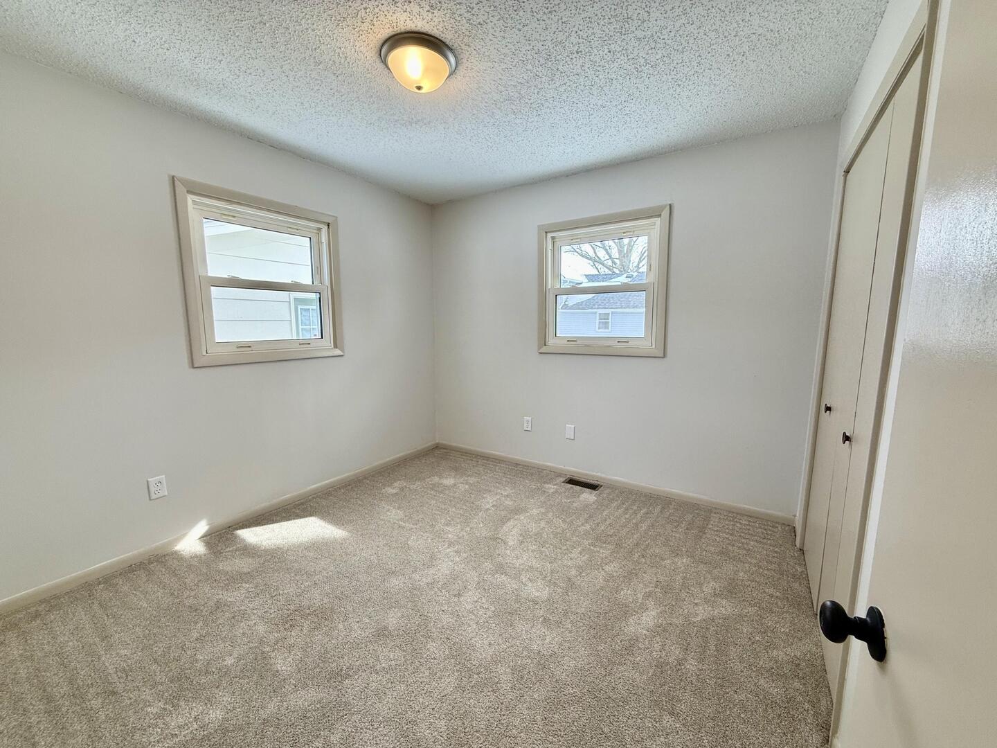 281 East Sprague Street Bement, IL 61813 - Photo 6 of 24 an empty room with a window