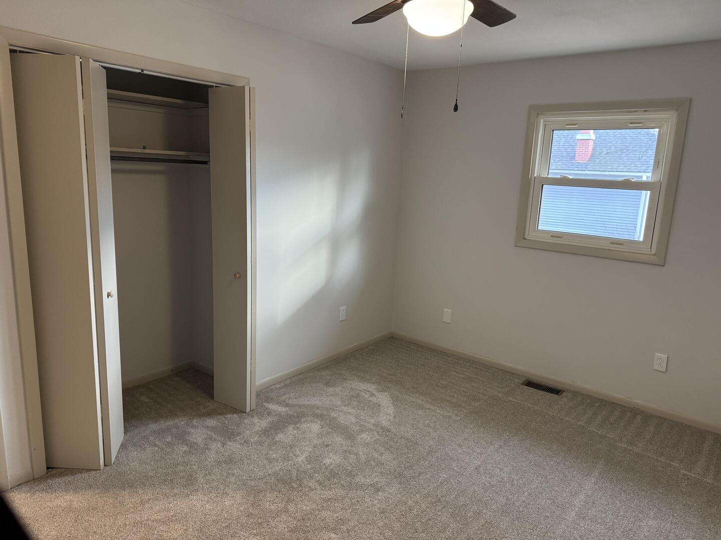 281 East Sprague Street Bement, IL 61813 - Photo 9 of 24 a view of an empty room with a window