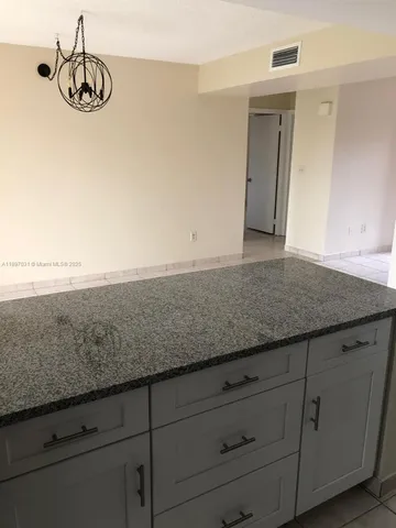a view of a kitchen counter space and cabinets