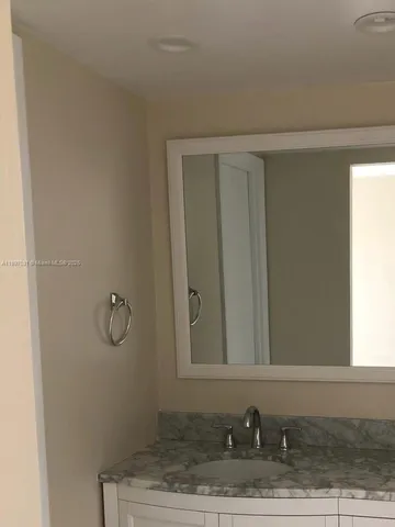 a bathroom with a sink and vanity