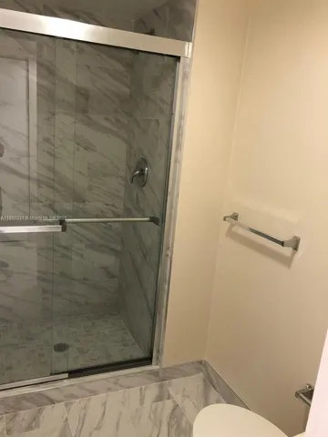 a bathroom with a shower and toilet
