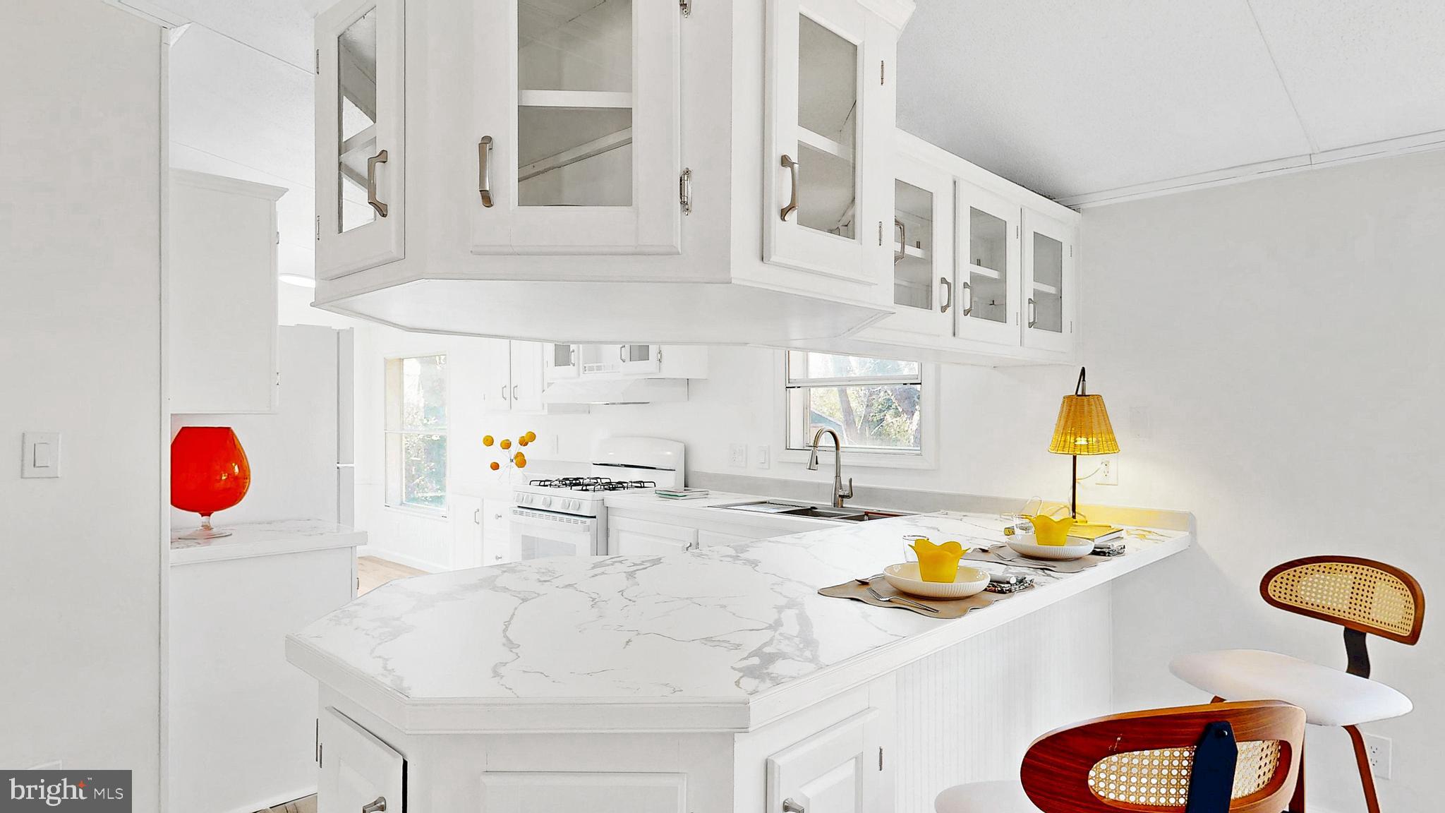 224 Shamrock Avenue Dover, DE 19901 - Photo 7 of 52 a kitchen with stainless steel appliances kitchen island granite countertop a sink and a white cabinets