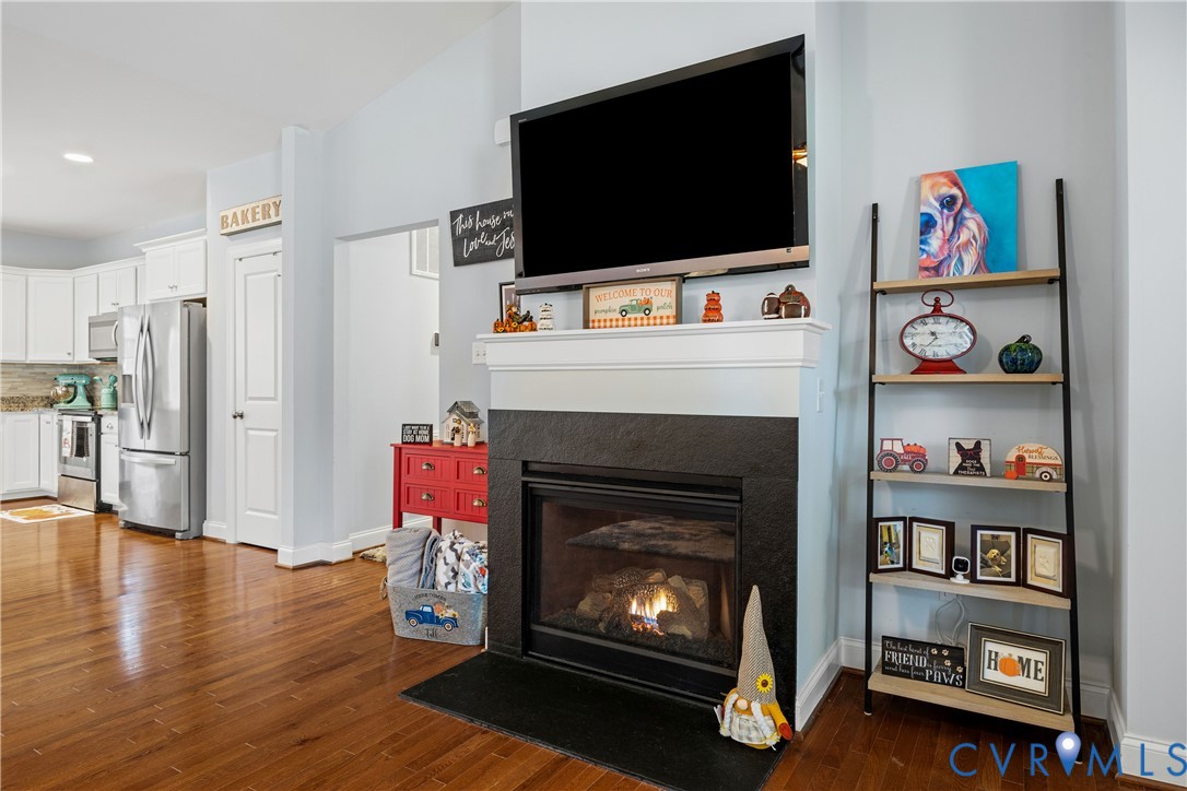 4875 Kimber Lane Gum Spring, VA 23065 - Photo 19 of 48 a living room with furniture a flat screen tv and a fireplace