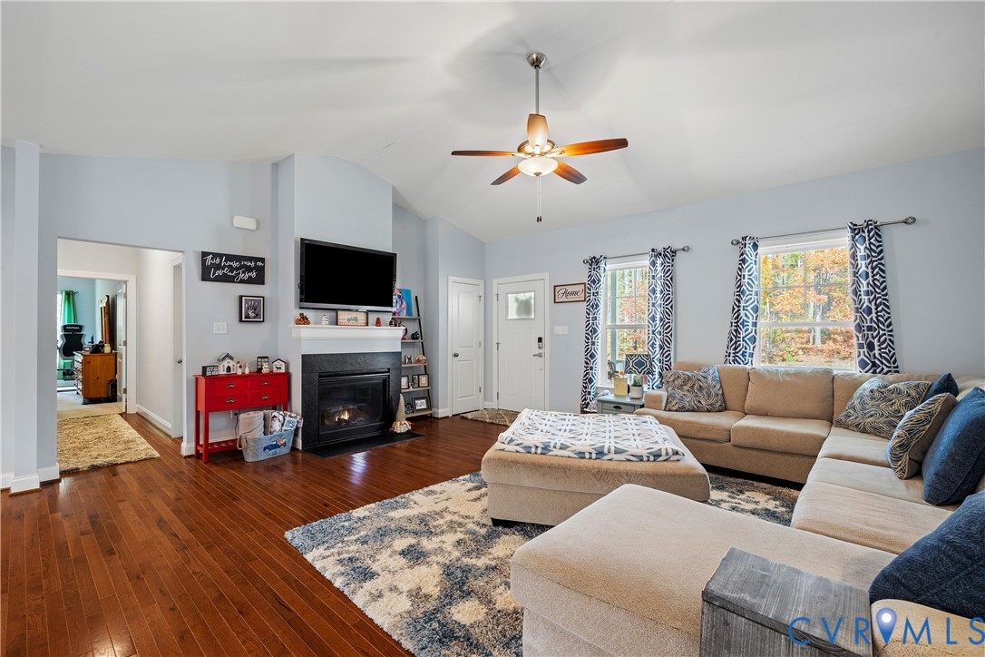 4875 Kimber Lane Gum Spring, VA 23065 - Photo 20 of 48 Living area with dark wood finished floors, a fire