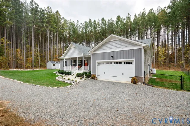 a front view of a house with a yard outdoor seating and garage