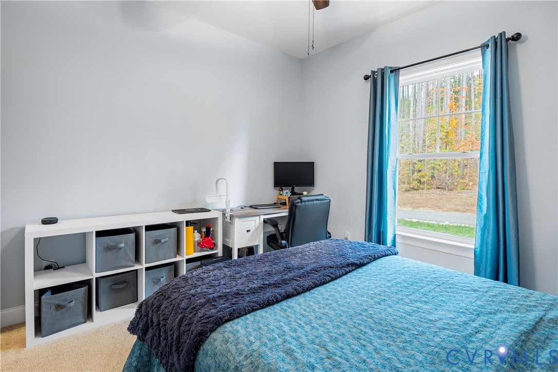 4875 Kimber Lane Gum Spring, VA 23065 - Photo 33 of 48 a bedroom with a bed and a flat tv screen