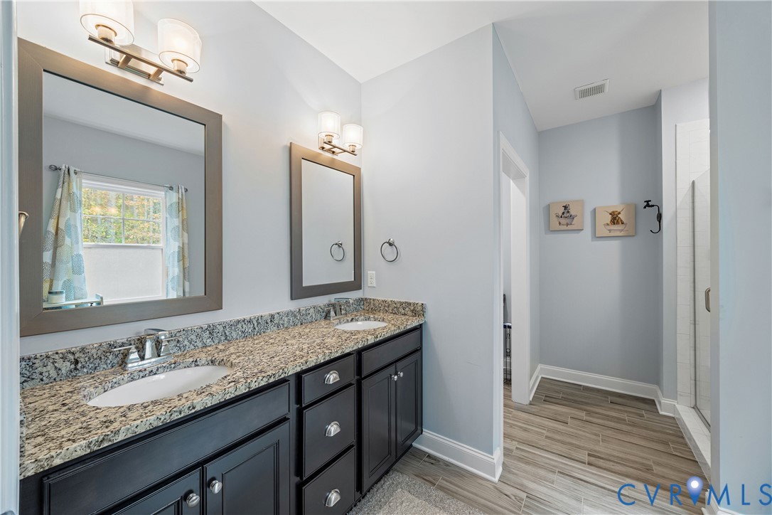 4875 Kimber Lane Gum Spring, VA 23065 - Photo 37 of 48 a bathroom with a granite countertop sink and a mirror