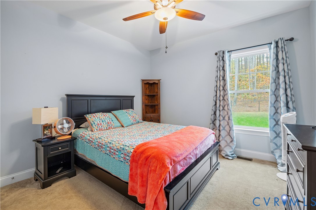 4875 Kimber Lane Gum Spring, VA 23065 - Photo 39 of 48 a bedroom with a bed and a chandelier