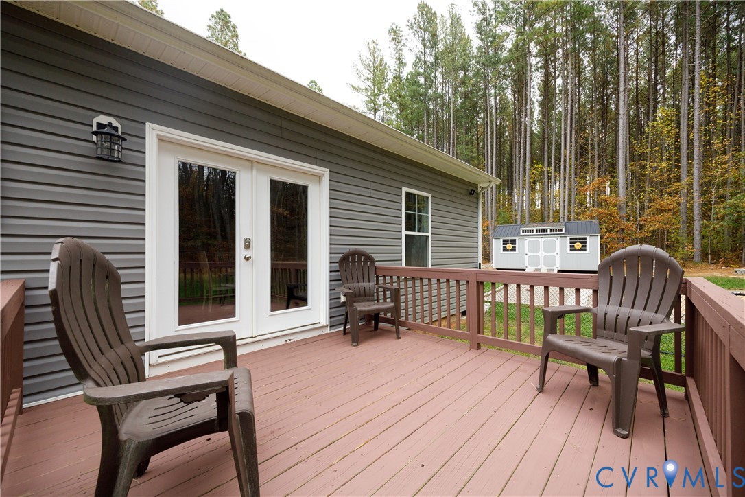 4875 Kimber Lane Gum Spring, VA 23065 - Photo 10 of 48 a balcony with wooden floor table and chairs
