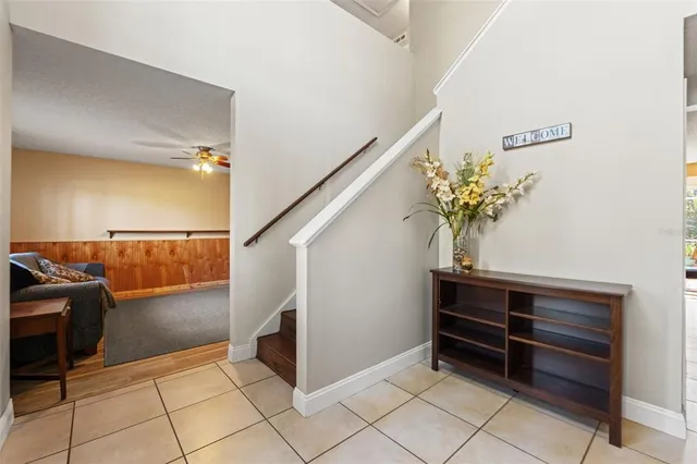 a kitchen with stainless steel appliances granite countertop a refrigerator a stove and white cabinets with wooden floors