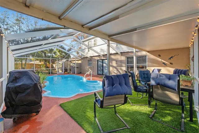 a view of a patio with table and chairs and potted plants