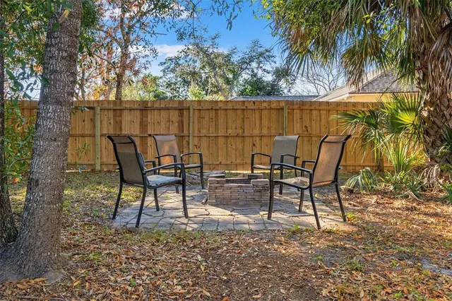 a view of a swimming pool with a patio and a chandelier