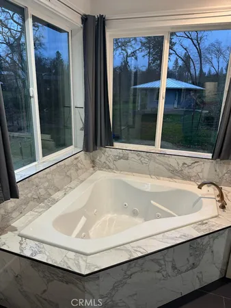 a bath tub sitting next to a window