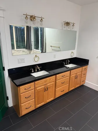 a bathroom with a sink double vanity and a mirror