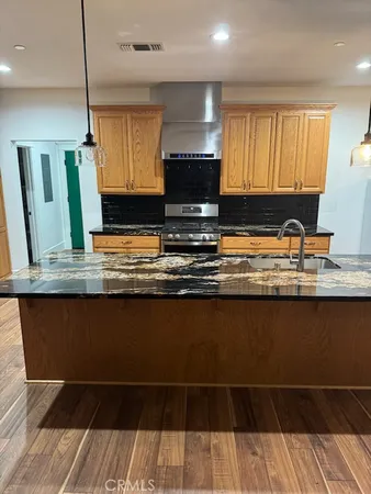 a kitchen with a sink a microwave a stove and cabinets