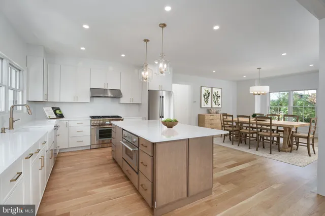 a kitchen with lots of counter top space a sink appliances and cabinets