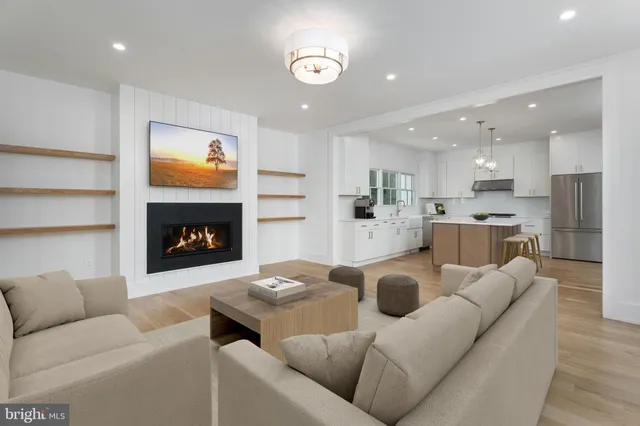 a view of an empty room with a fireplace and a window