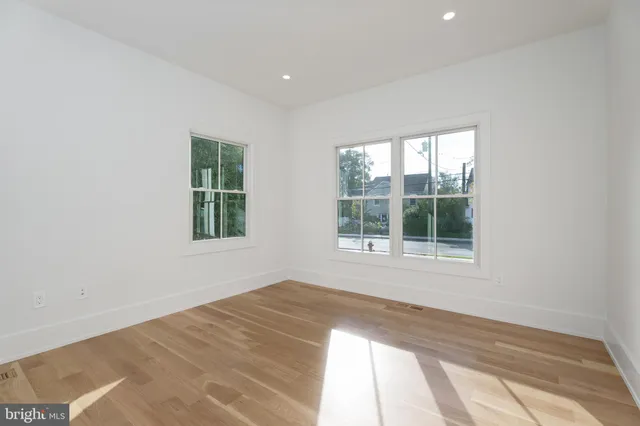 a view of staircase with railing and white walls