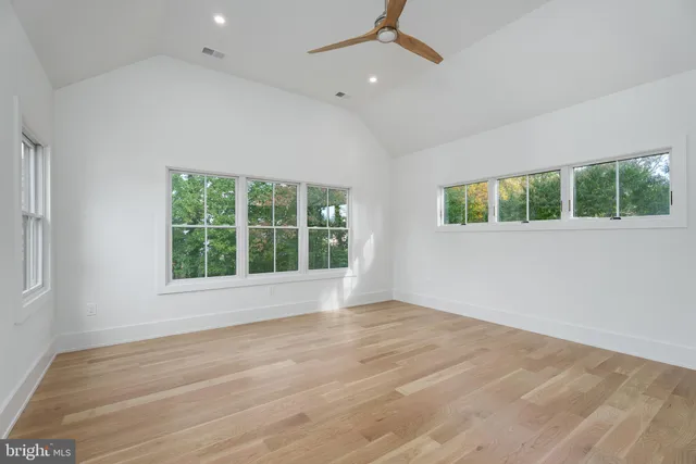 a bedroom with a large bed and a large window