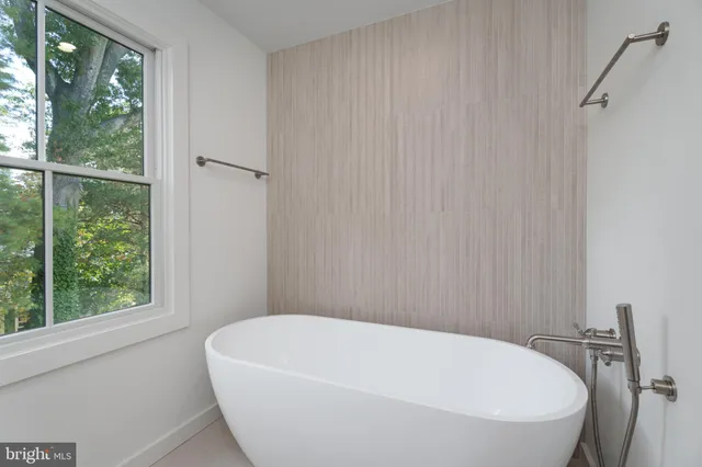 a bathroom with double vanity and a mirror