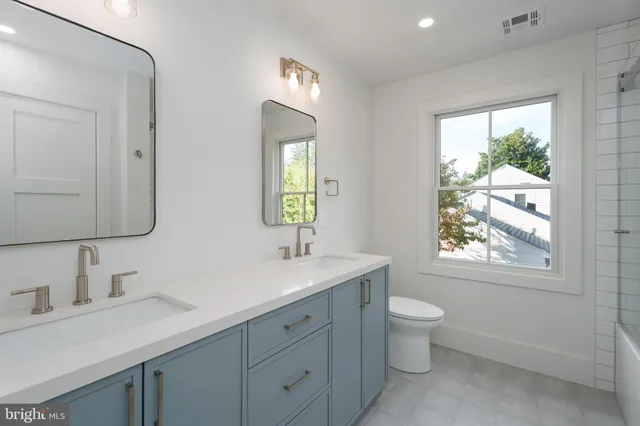 a room with pool table and windows