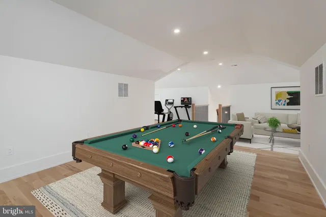 a room with furniture pool table and windows