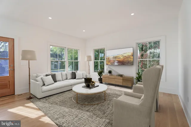 a living room with furniture and floor to ceiling windows