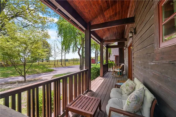 a view of porch with furniture and trees
