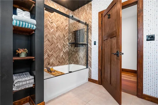 a bathroom with a tub and shower